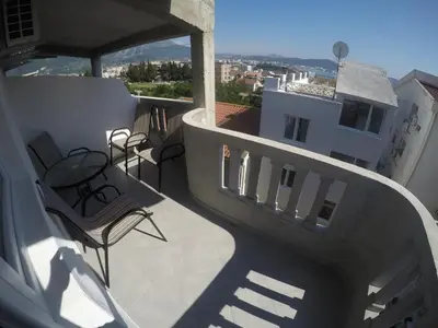a balcony with chairs and a table on a building at Apartments Miki in Bar