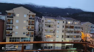 a group of apartment buildings with mountains in the background at Budva apartman Haustor in Budva