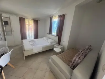 a small bedroom with a bed and a couch at Apartments Radosevic in Ulcinj