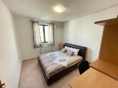 a bedroom with a bed with two towels on it at Apartments Radosevic in Ulcinj