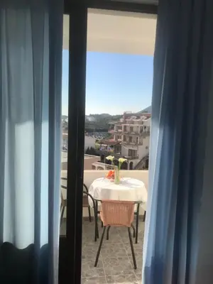 a table and chairs on a balcony with a view at Apartments Radosevic in Ulcinj