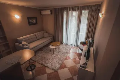 a living room with a couch and a table at Apartment Podgorica Center in Podgorica