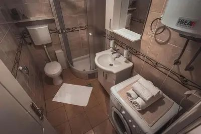 a small bathroom with a sink and a toilet at Apartment Podgorica Center in Podgorica