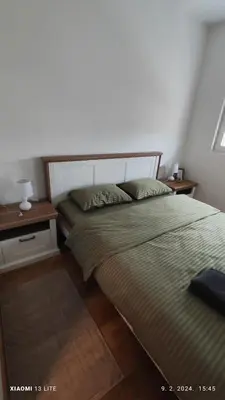 a bedroom with a bed and a nightstand and a bed sidx sidx sidx sidx at Vincent Van Gogh in Podgorica