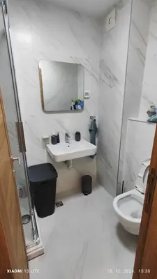 a white bathroom with a sink and a toilet at Vincent Van Gogh in Podgorica