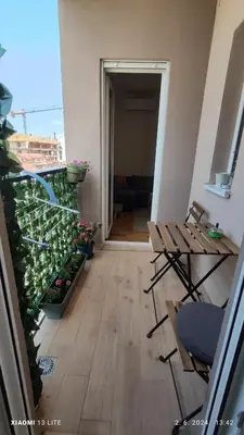a balcony with plants and a table and chairs at Vincent Van Gogh in Podgorica