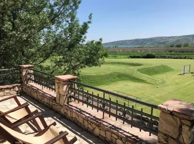 a view from the balcony of a golf course at Shasi Eco Lodge in Ambula