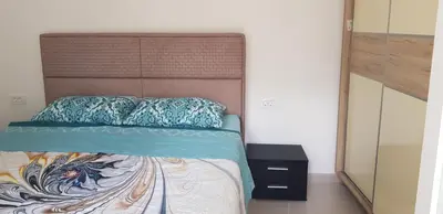 a bedroom with a bed with a large headboard at Vila Kajevic in Ulcinj