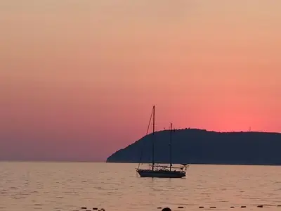 a sail boat in the water at sunset at Digital Nomads Camp in Bar, Susanj