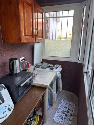 a small kitchen with a stove and a sink at Квартира 200м от моря. in Bar