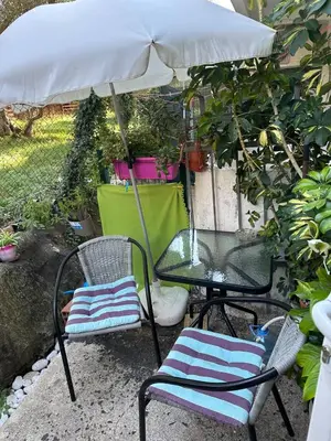 a table and chairs under an umbrella on a patio at Квартира 200м от моря. in Bar