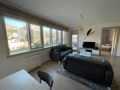 a living room with a couch and a table at Lux apartment Komel in Budva
