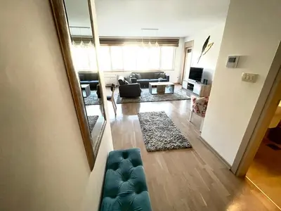 a living room with a couch and a mirror at Lux apartment Komel in Budva