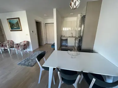 a white dining table and chairs in a kitchen at Lux apartment Komel in Budva