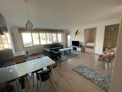 a living room with a table and a couch at Lux apartment Komel in Budva