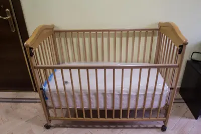a crib sitting in a room next to a door at Villa Danile Cosy Apartments in Budva