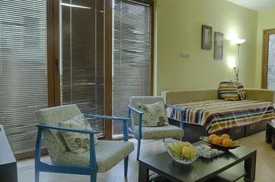 a living room with two chairs and a table at Villa Danile Cosy Apartments in Budva