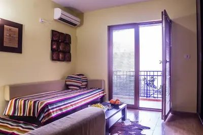 a living room with a couch and a sliding glass door at Villa Danile Cosy Apartments in Budva