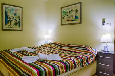 a bedroom with a bed with bows on it at Villa Danile Cosy Apartments in Budva