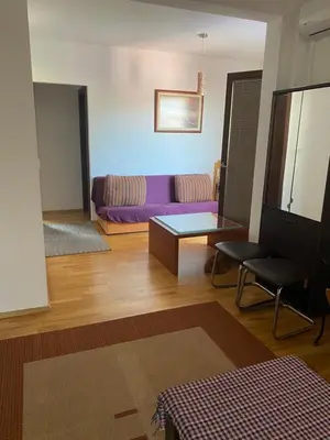 a living room with a purple couch and a table at Apartments Ivan in Petrovac na Moru
