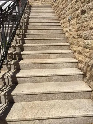 a set of stairs leading up to a brick wall at Apartments Ivan in Petrovac na Moru
