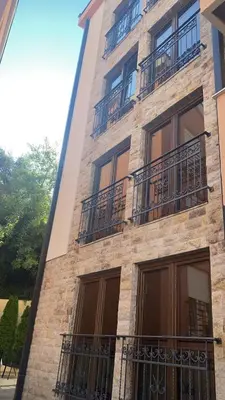 a building with balconies on the side of it at Apartments Ivan in Petrovac na Moru