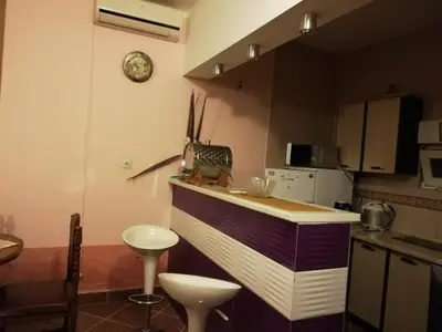 a kitchen with a counter and a clock on the wall at Apartments Svetlana in Utjeha