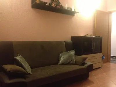 a couch with two pillows on it in a living room at Apartments Svetlana in Utjeha