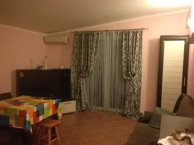 a living room with a couch and a window at Apartments Svetlana in Utjeha