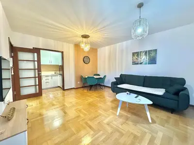 a living room with a couch and a table at Comfort Family Apartment Eva in Budva