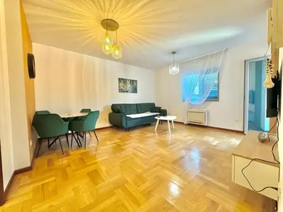 a living room with a couch and a table at Comfort Family Apartment Eva in Budva