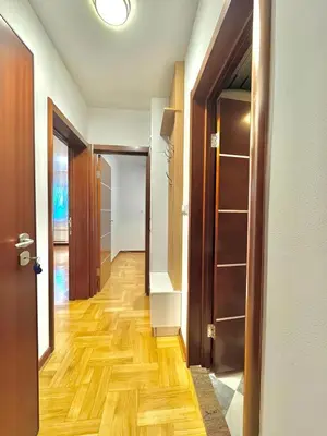 an empty hallway with wooden floors and doors at Comfort Family Apartment Eva in Budva