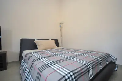 a bedroom with a bed with a pillow and a lamp at Apartments Spas in Budva