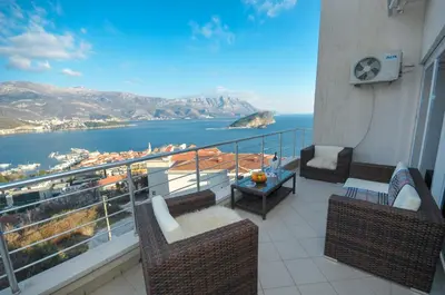 a balcony with chairs and a view of the water at Apartments Spas in Budva