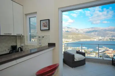a kitchen with a balcony with a view of the water at Apartments Spas in Budva
