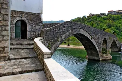 a stone bridge over a body of water at Apartment Jovicevic in Rijeka Crnojevića