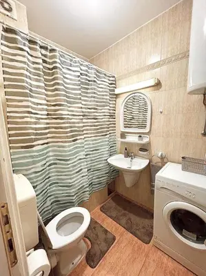 a bathroom with a toilet and a sink at Cozy, charming one bedroom apt in Podgorica