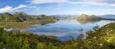 a view of a lake with mountains in the background at Ethno House Ivanovic in Virpazar