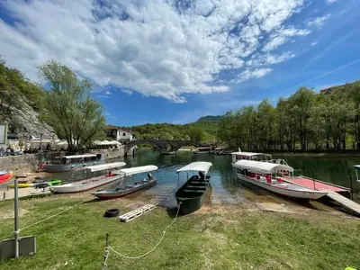 a group of boats are docked in a river at Ethno House Ivanovic in Virpazar