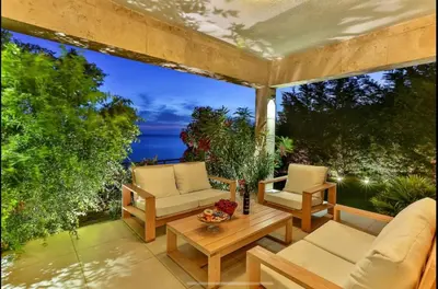 an outdoor patio with two chairs and a table at Wall Villa in Bar