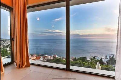 a room with a large window looking out at the ocean at Wall Villa in Bar