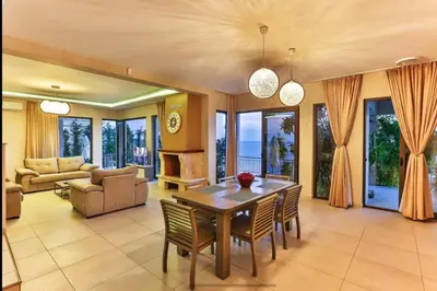 a living room with a wooden table and chairs at Wall Villa in Bar