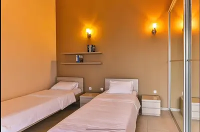 two beds sitting next to each other in a room at Wall Villa in Bar