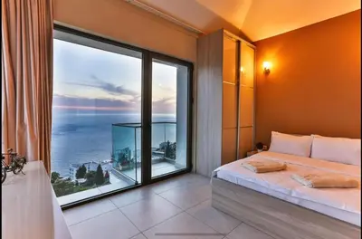 a bedroom with a large window with a view of the ocean at Wall Villa in Bar