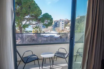 a balcony with chairs and a table and a window at Botanica Boutique Hotel in Ulcinj