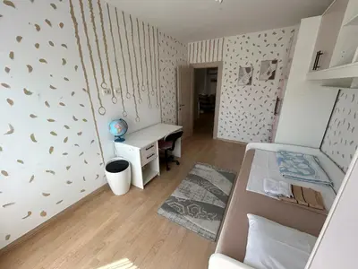 a small room with a bed and a desk at Ana’s 2 bedrooms lovely flat in Podgorica