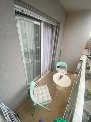 a room with a table and chairs and a window at Ana’s 2 bedrooms lovely flat in Podgorica