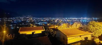 a view of a city at night with lights at Owl's Nest in Bar
