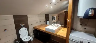 a small bathroom with a toilet and a sink at Owl's Nest in Bar