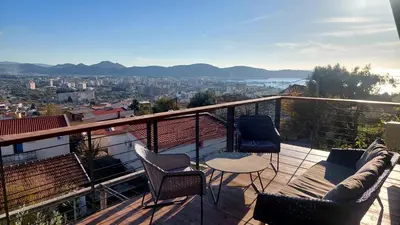 a balcony with chairs and a table and a view at Owl's Nest in Bar